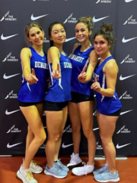 Girls posing for a picture as they placed first in their track event. 
(Photo courtesy of NVD Track Instagram)