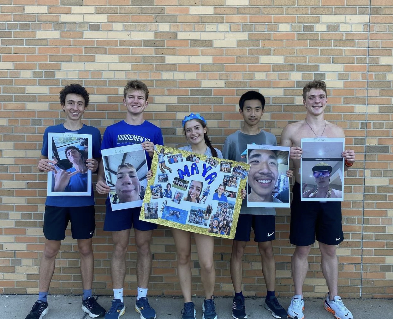 (Photo courtesy of Maya Gueguen) 
Caption: Senior, cross country runners show their posters they received on senior night.
