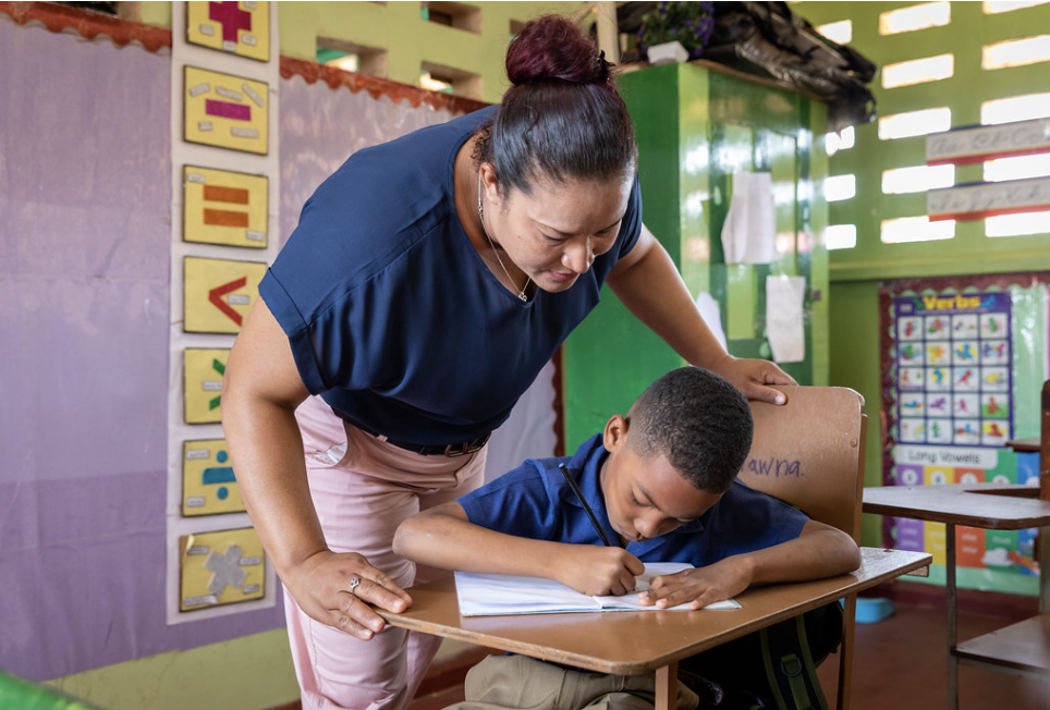 Teacher helping student