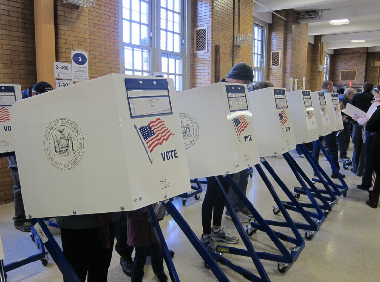 People at voting booths.