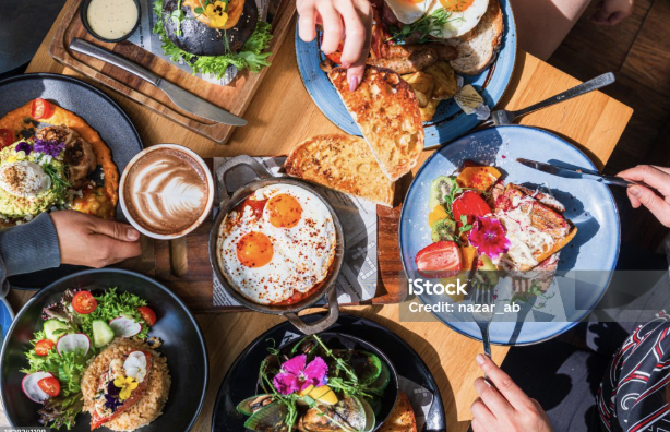 Table top view of breakfast food displayed on table.