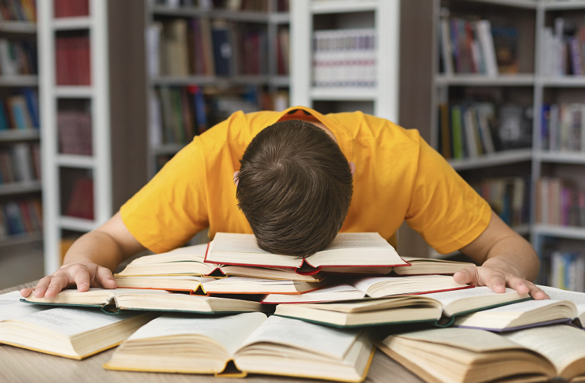 An image of an overwhelmed and stressed student. 
