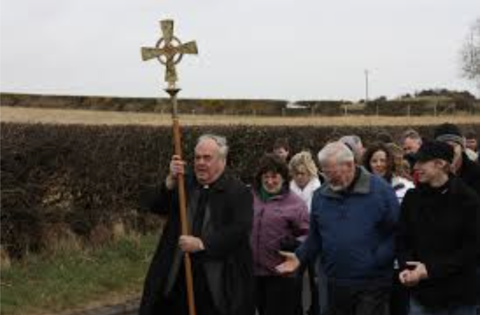 Members of a local church following their Priest, celebrating Saint Patrick's day.