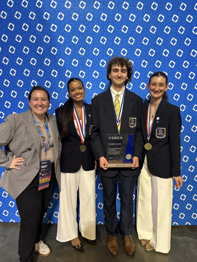 A picture of DECA advisor, Melissa Petrella and students Jonah Wagner, Samaaya Agarwal and Ava Pavlos 
